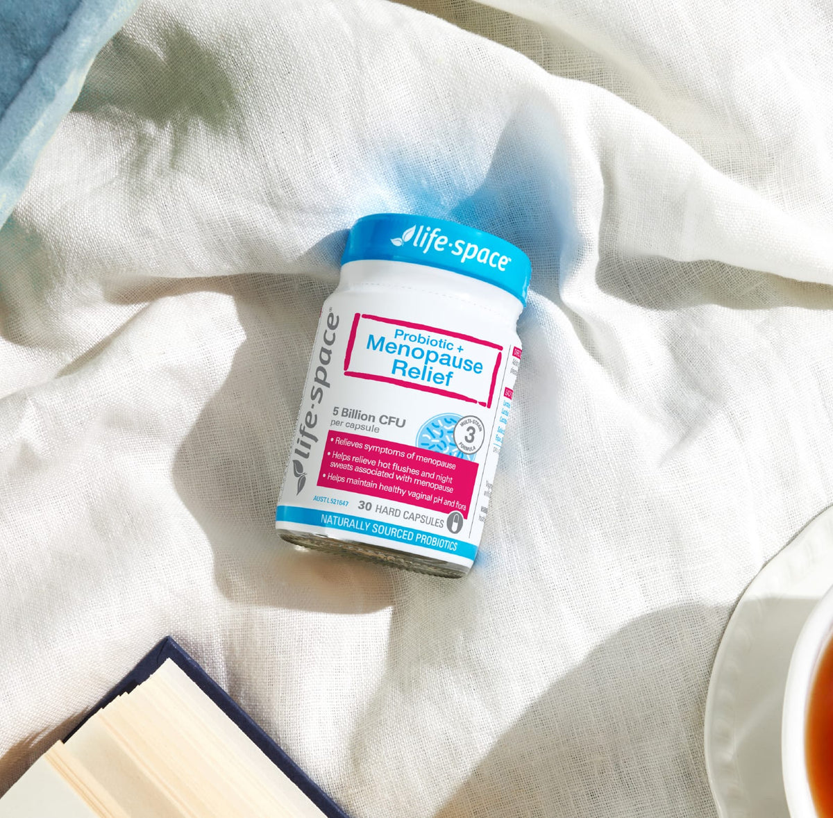 Life-Space Probiotic + Menopause Relief bottle on a white fabric background