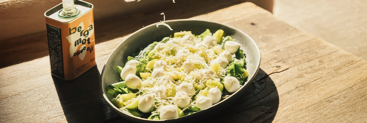 A prepared salad in bowl on a wooden table.